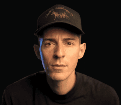 Young man wearing a black cap with getWSOdownload logo.